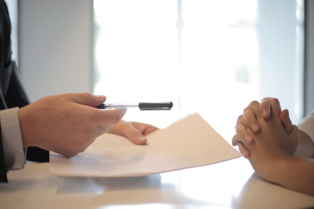 A person giving a contract to another person to sign