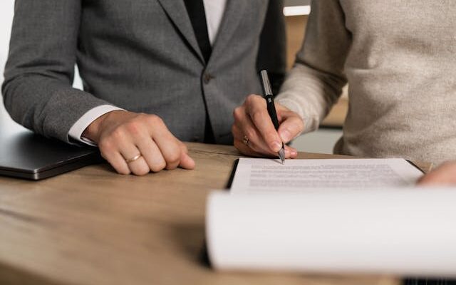 two people signing lease
