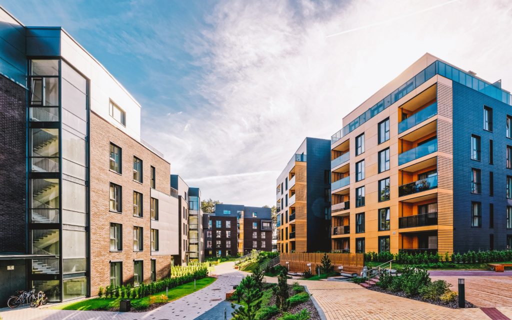 Modern apartment buildings around a landscaped courtyard