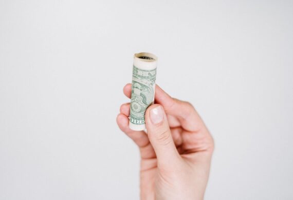 person holding rolled up bill