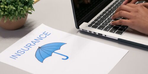 insurance paperwork and laptop