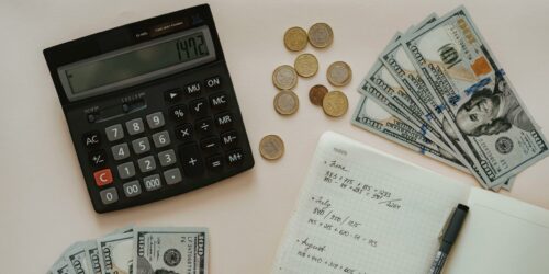 calculator money coins and cash for budgeting.